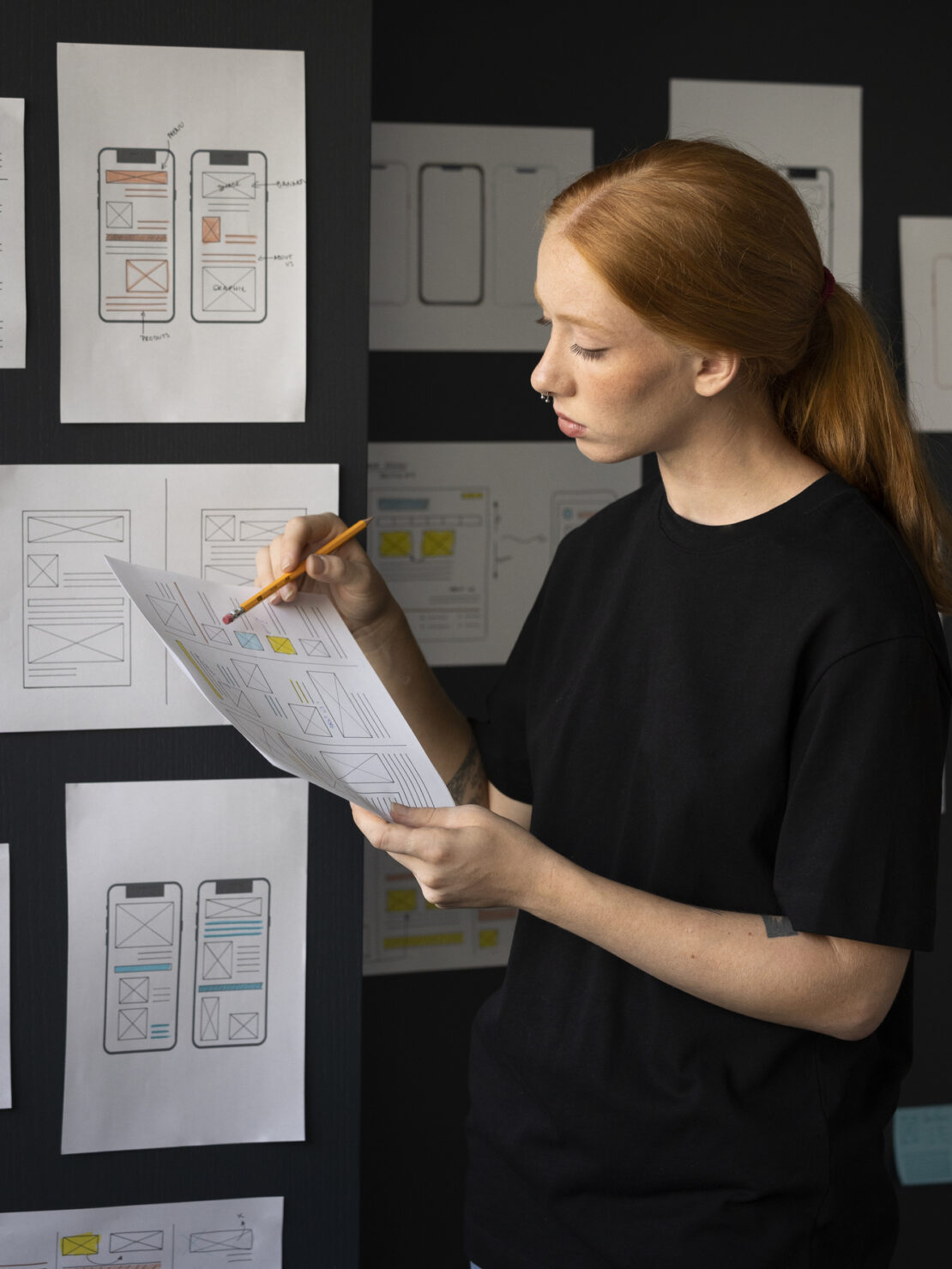 female-web-designer-taking-notes-office (1)